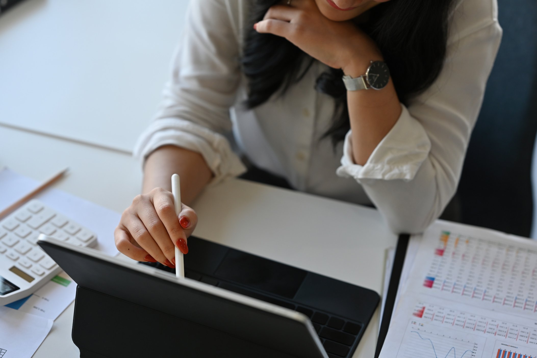 Close up with female accountant using tablet, finance accoun